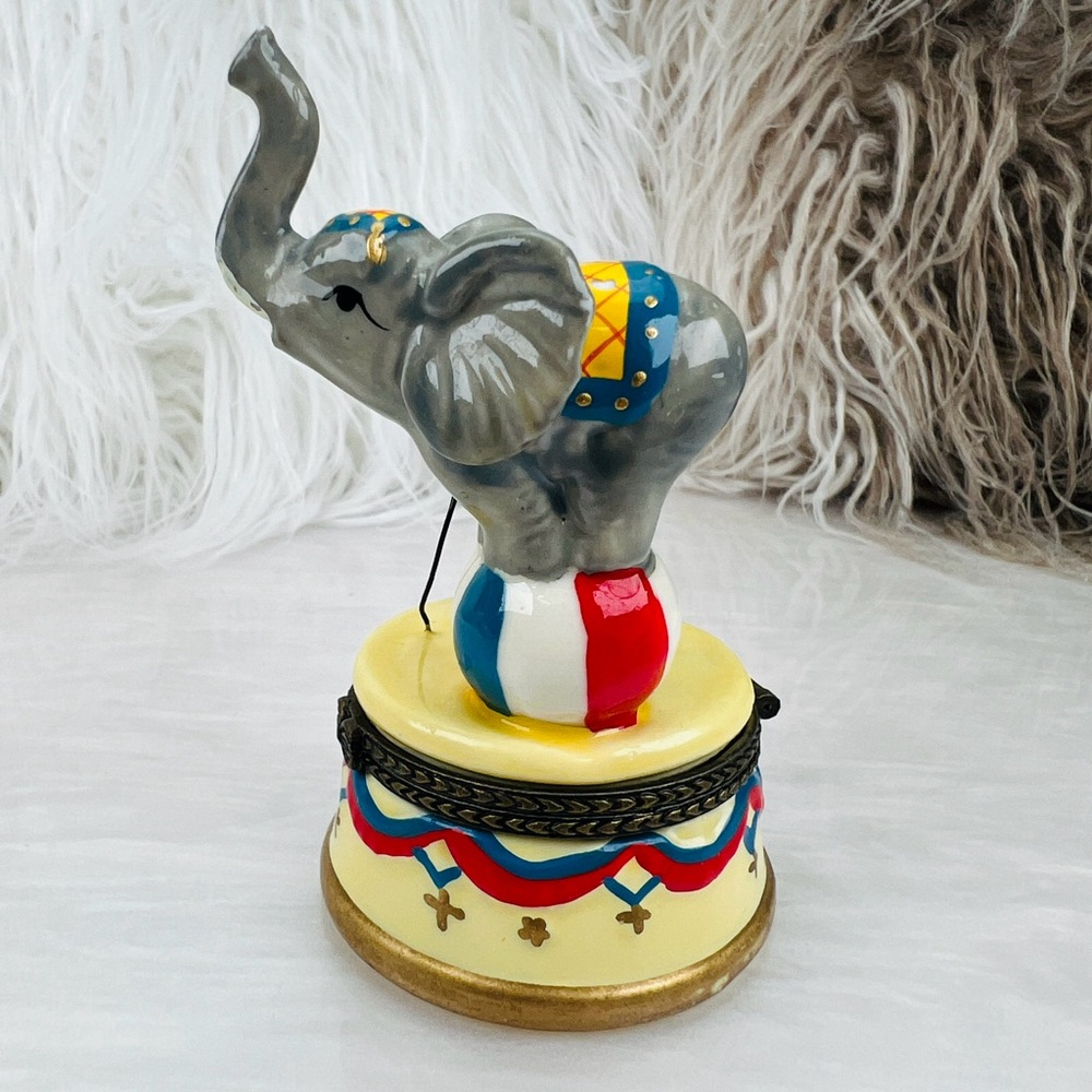 Vintage circus elephant balancing on a ball with a ringmaster trinket box.